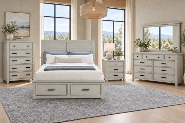 Willowbrook light gray storage bed with nightstand, dresser, mirror and chest in an airy bedroom